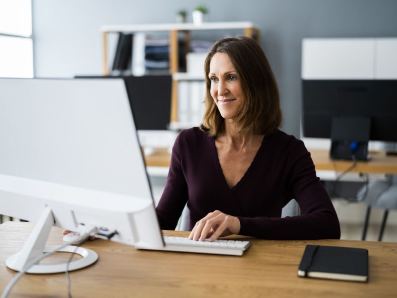 A woman using faxing software in the office 