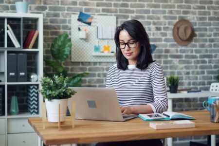 A female professional using faxing software to secure document transmission in a digital workspace.