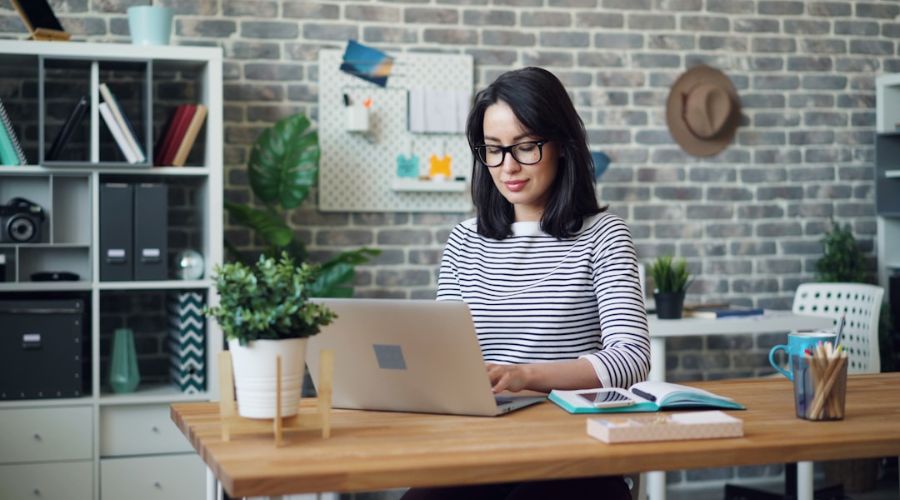 A female professional using faxing software to secure document transmission in a digital workspace.