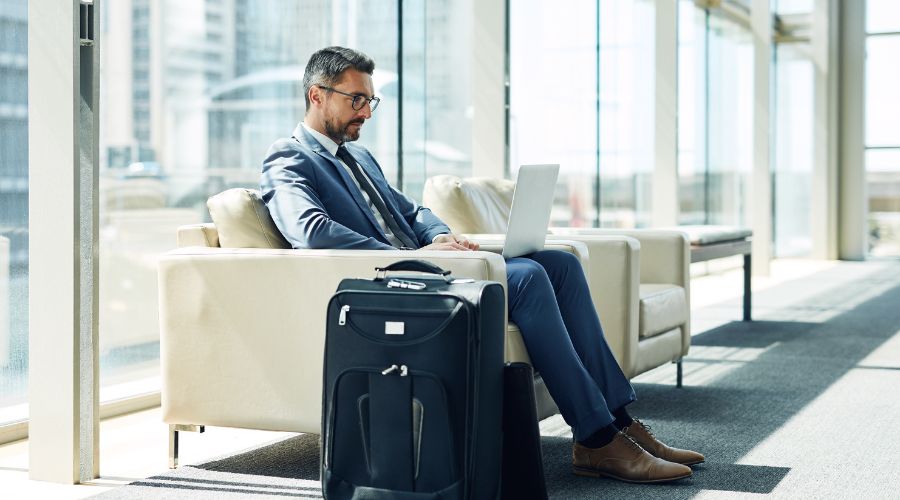 Man at the airport using a laptop