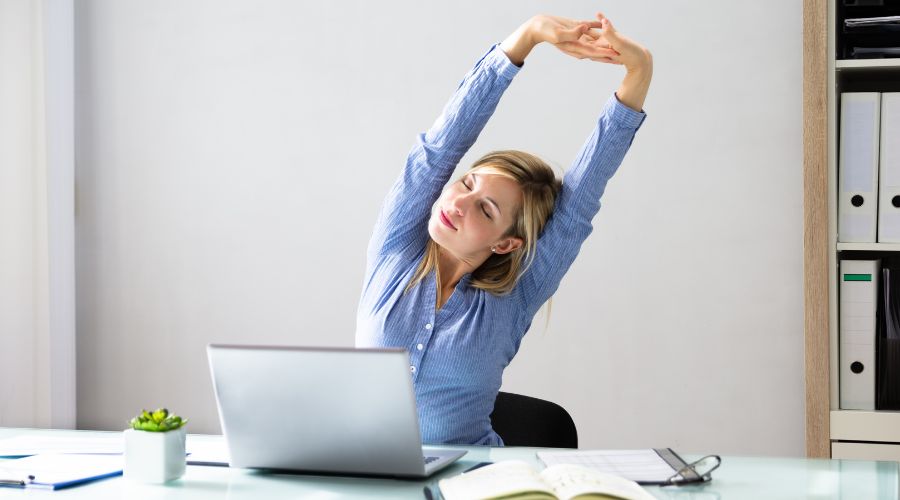 Woman stretching at desk 