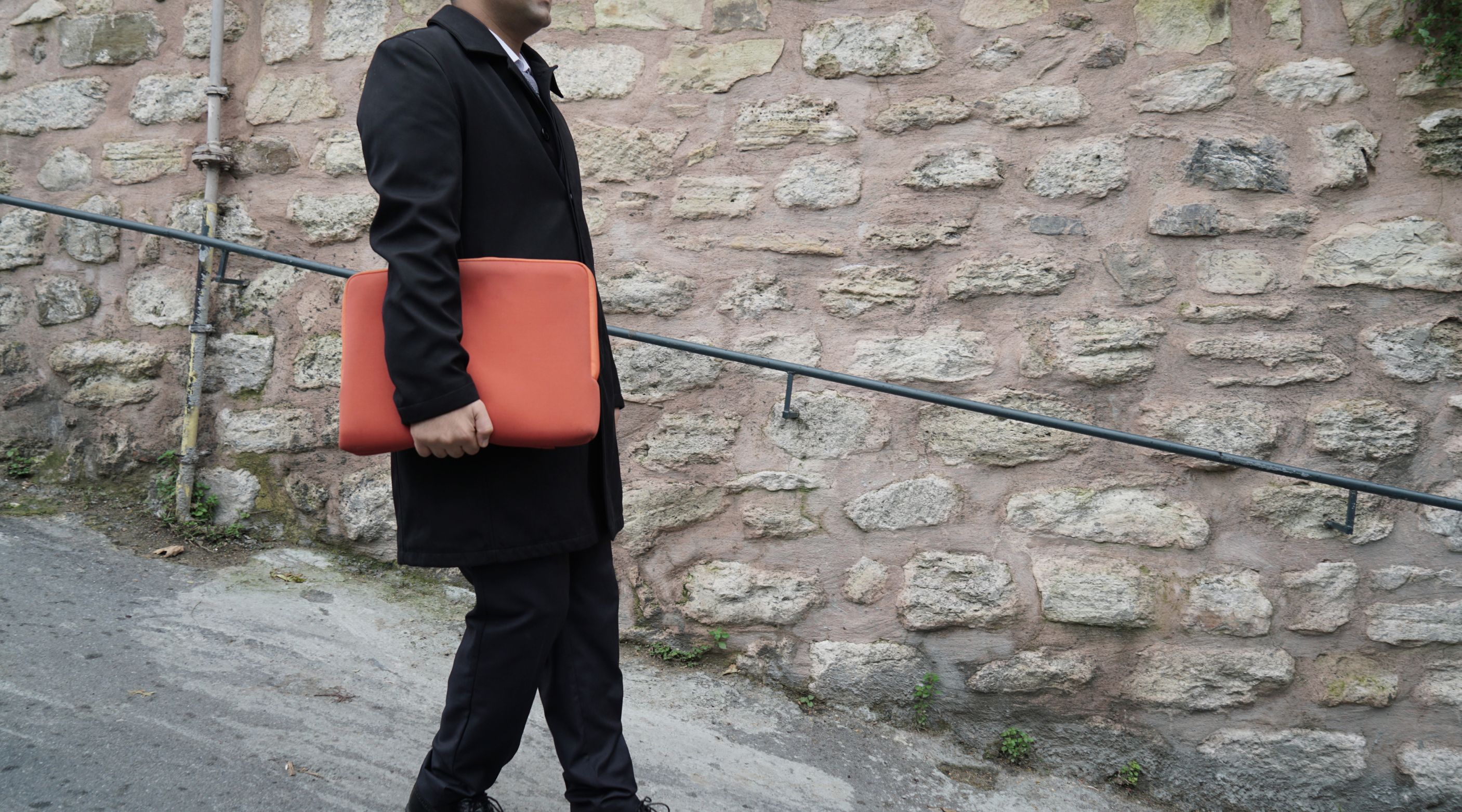 Man with orange laptop bag