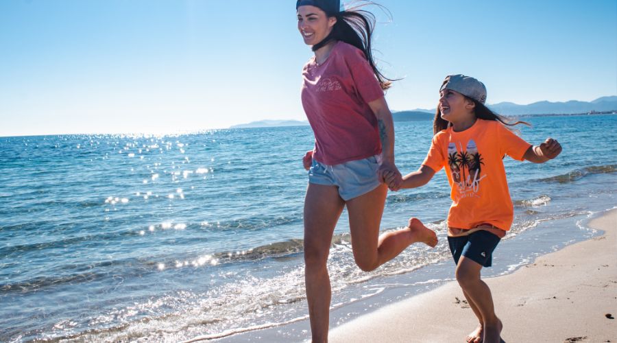 Mum and child running on the beach